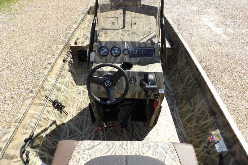Slide: The Image of 2026 Crestliner 1860 Retriever CC boat interior with camouflage design and steering console. - 21