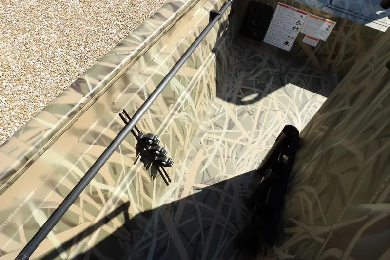 Slide: The Image of Interior view of 2026 Crestliner 1860 Retriever CC boat with camouflage design. - 22