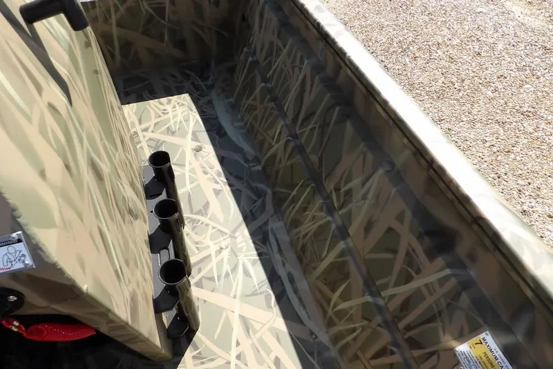 Slide: The Image of 2026 Crestliner 1860 Retriever CC interior with camouflage design and rod holders. - 24