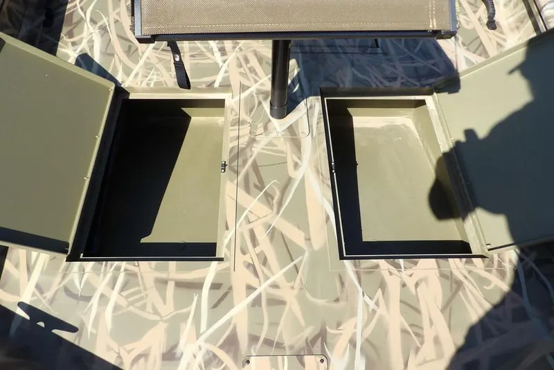 Slide: The Image of 2026 Crestliner 1860 Retriever CC boat with open storage compartments and camouflage design. - 29