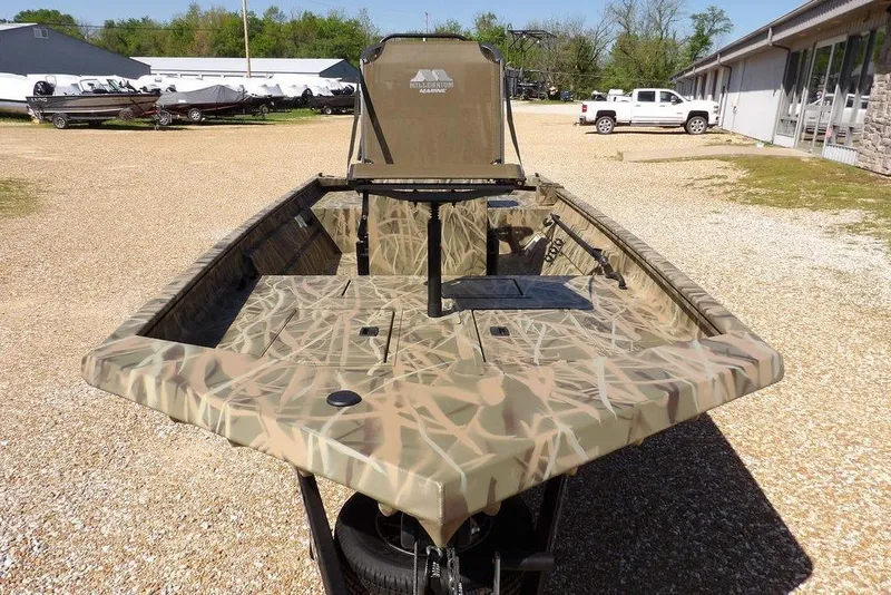 Slide: The Image of 2026 Crestliner 1860 Retriever CC boat with camouflage design, parked outdoors. - 3