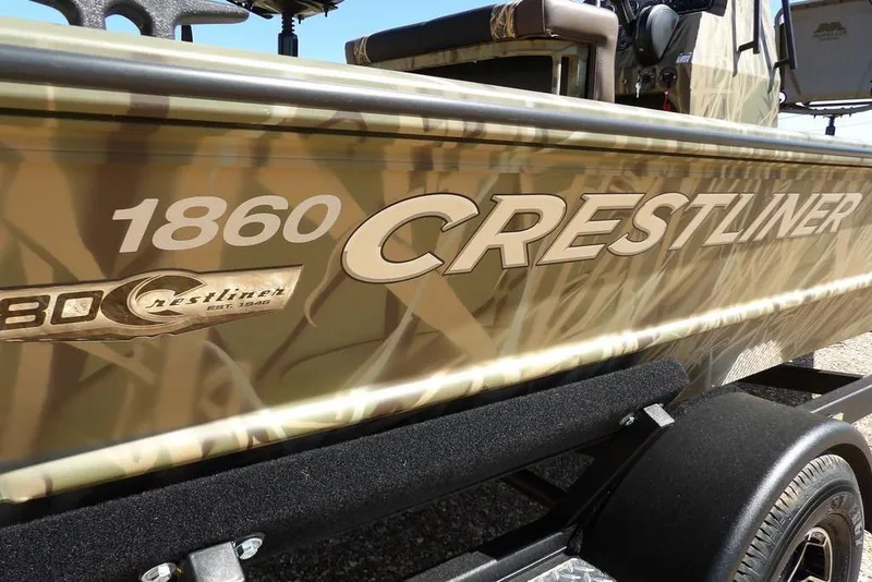 Slide: The Image of 2026 Crestliner 1860 Retriever CC boat with camouflage design on trailer. - 30