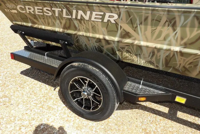 Slide: The Image of 2026 Crestliner 1860 Retriever CC boat on trailer with camouflage design. - 32
