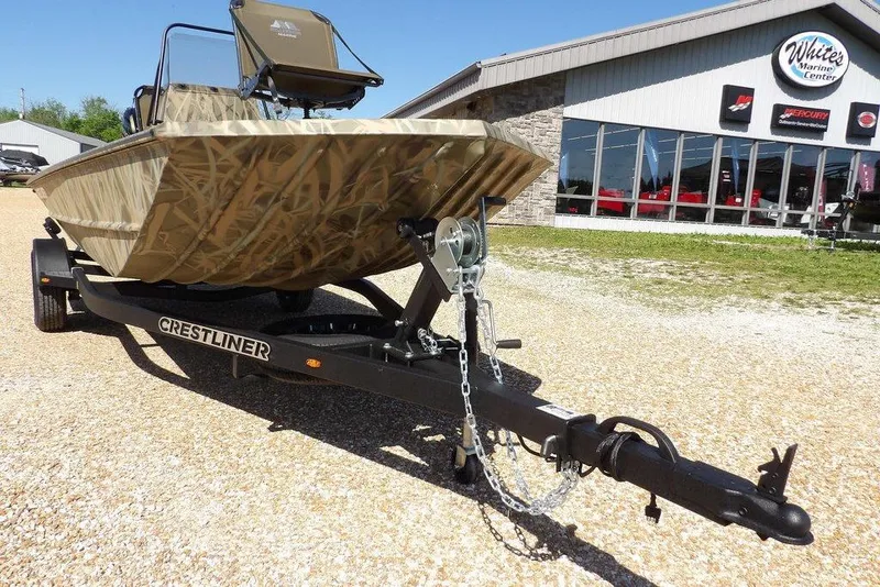 Slide: The Image of 2026 Crestliner 1860 Retriever CC boat on trailer outside marine center. - 33