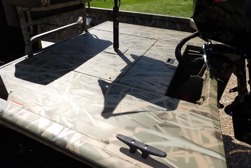 Slide: The Image of 2026 Crestliner 1860 Retriever CC boat deck with camouflage pattern and motor. - 4