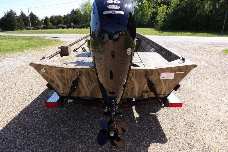 Slide: The Image of 2026 Crestliner 1860 Retriever CC boat with camo design and powerful outboard motor. - 7