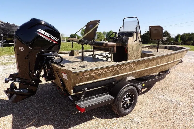Slide: The Image of 2026 Crestliner 1860 Retriever CC boat with Mercury engine on a trailer, outdoors. - 8