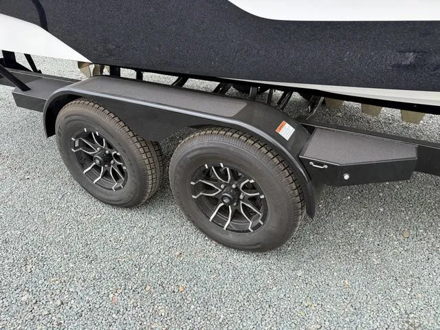 Slide: The Image of Dual trailer wheels of a 2026 MasterCraft XT22 boat. - 10