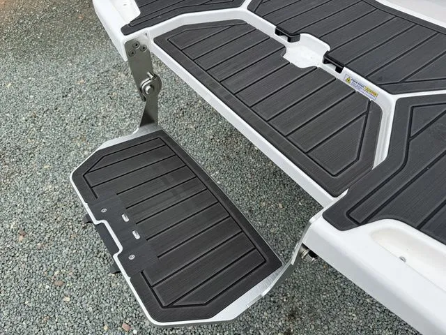 Slide: The Image of 2026 MasterCraft XT22 boat step on gravel surface. - 32