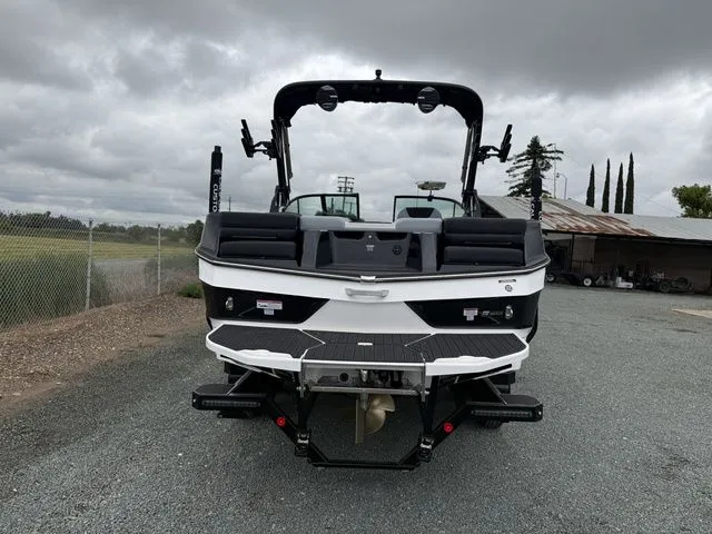 Slide: The Image of Rear view of 2026 MasterCraft XT22 boat on gravel surface. - 4