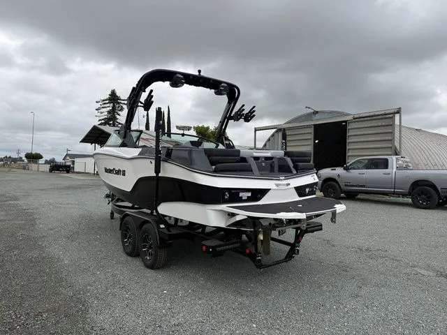 Slide: The Image of 2026 MasterCraft XT22 boat on trailer, overcast sky. - 5