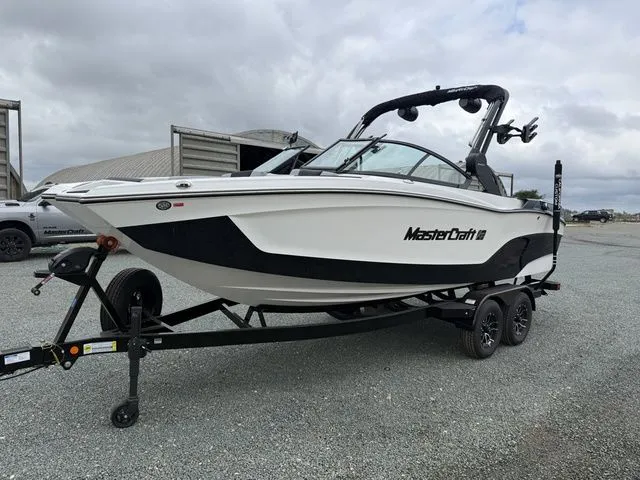 Slide: The Image of 2026 MasterCraft XT22 boat on trailer, side view. - 6