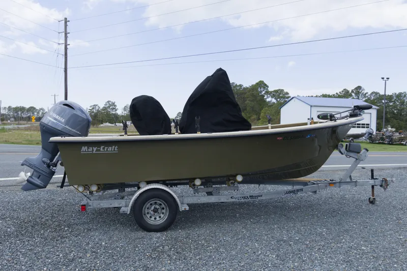 Slide: The Image of 2018 May-Craft 1800 Skiff on trailer with Yamaha outboard motor, parked outdoors. - 12