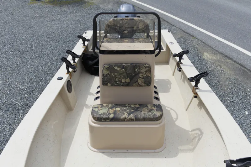 Slide: The Image of 2018 May-Craft 1800 Skiff with camouflage seating and rod holders on gravel. - 6