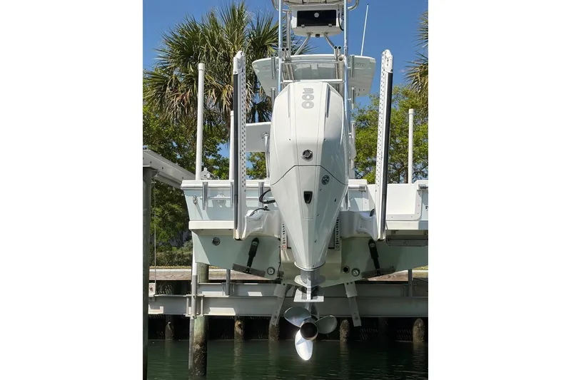 Slide: The Image of 2021 Pair Customs 24 Center Console MV boat docked with outboard motor. - 3