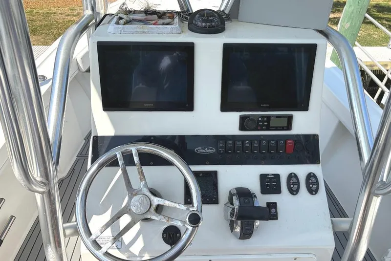 Slide: The Image of 2021 Pair Customs 24 Center Console MV dashboard with dual screens and steering wheel. - 7