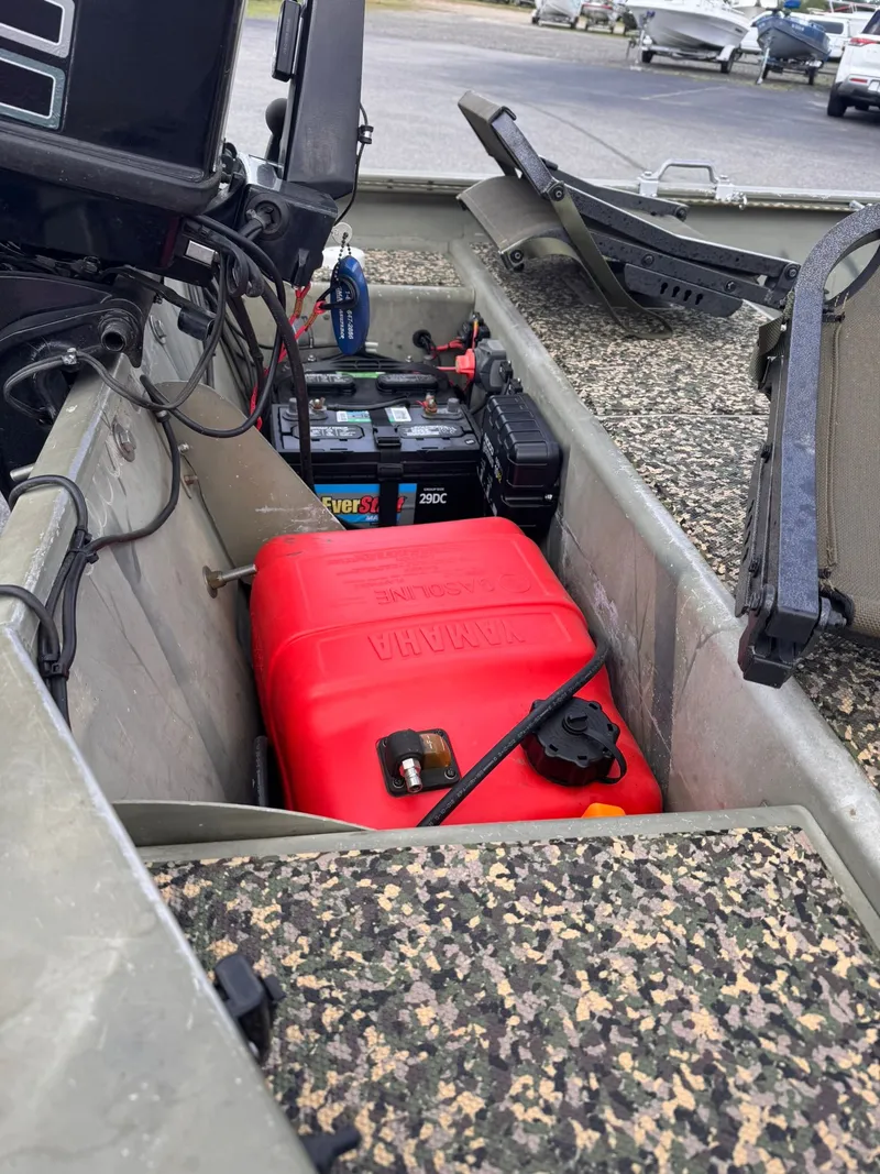 Slide: The Image of Interior of a Tracker Grizzly 1754 boat with Yamaha tank and battery. - 3