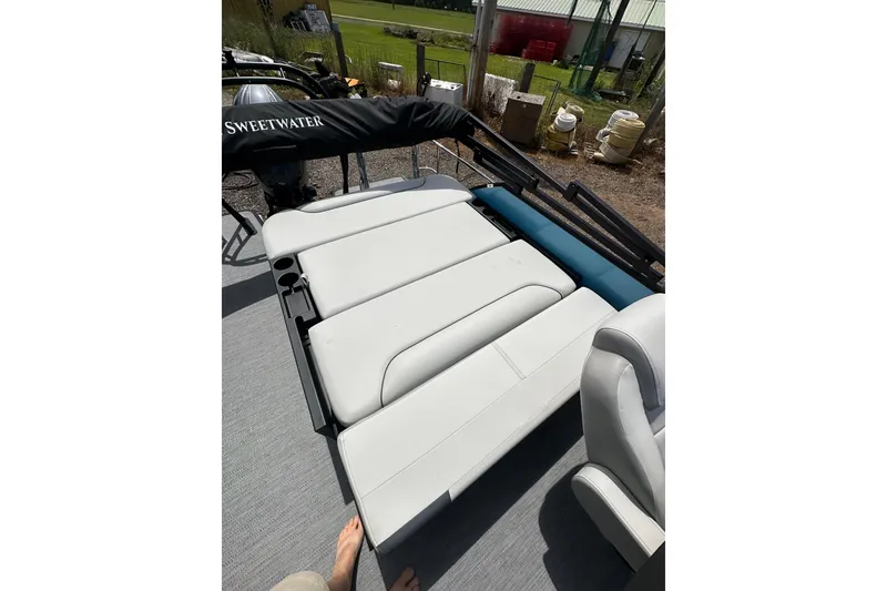 Slide: The Image of 2026 Godfrey Sweetwater 2286 SFLC boat interior with white cushioned seating and cup holders. - 19