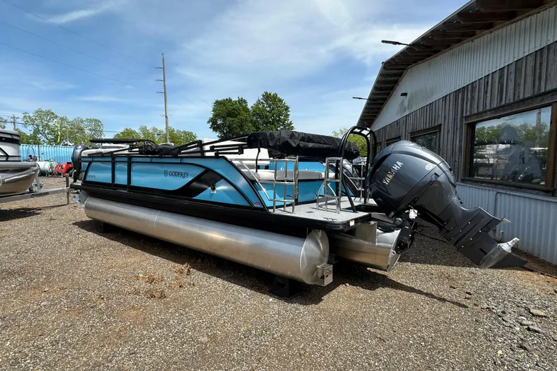 Slide: The Image of 2026 Godfrey Sweetwater 2286 SFLC pontoon boat with Yamaha outboard motor, parked outdoors. - 2