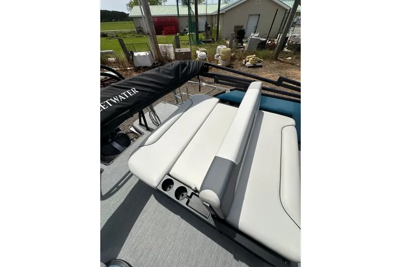 Slide: The Image of 2026 Godfrey Sweetwater 2286 SFLC boat interior with cushioned seating and cup holders. - 20