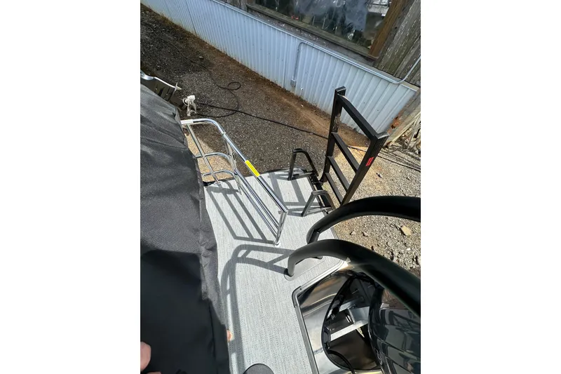 Slide: The Image of 2026 Godfrey Sweetwater 2286 SFLC boat deck with metal railings and ladder. - 22