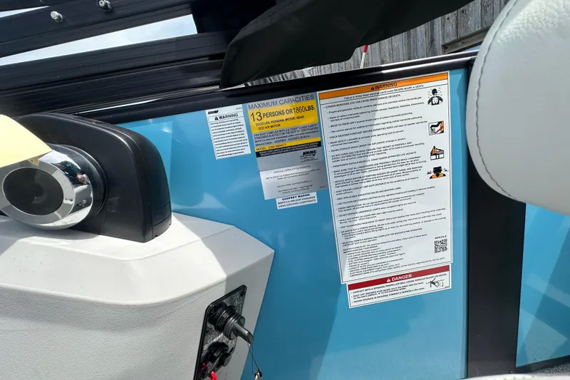 Slide: The Image of 2026 Godfrey Sweetwater 2286 SFLC boat dashboard with capacity and safety warnings. - 25