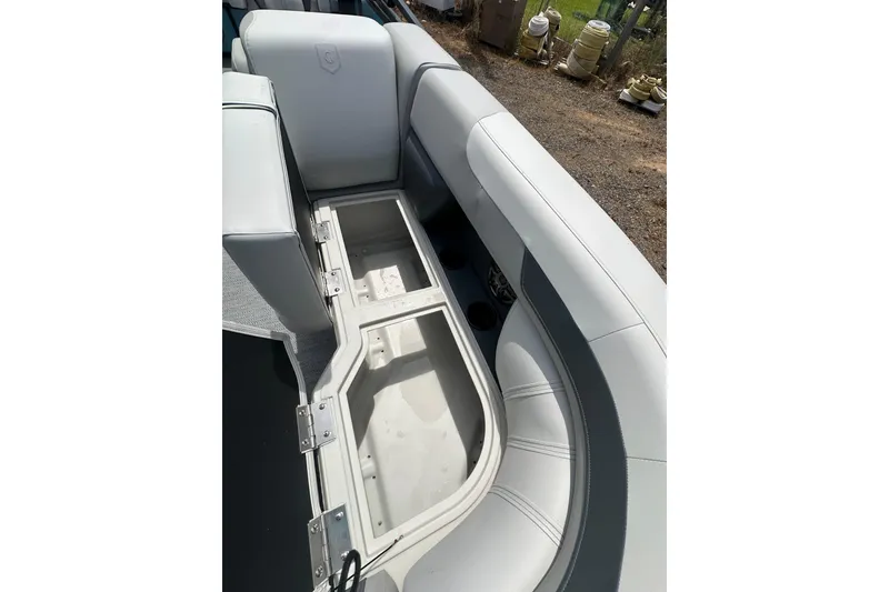 Slide: The Image of Open storage compartment in 2026 Godfrey Sweetwater 2286 SFLC boat with cushioned seating. - 28