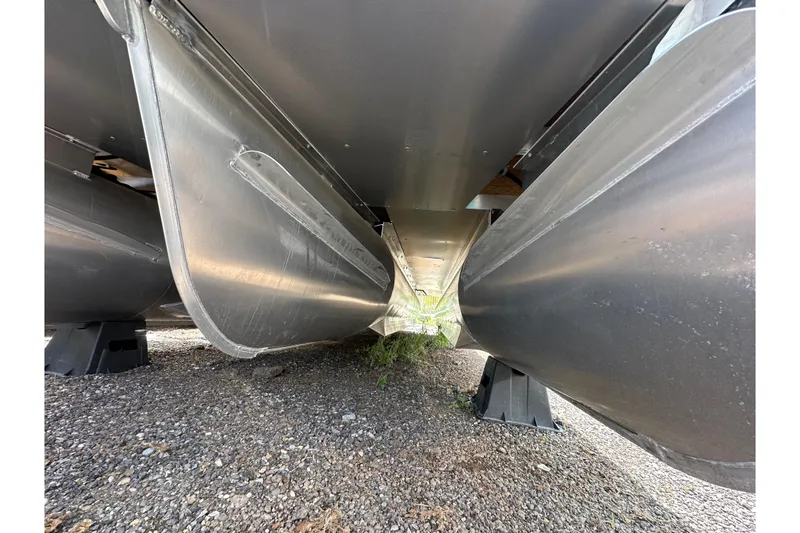 Slide: The Image of Underneath view of 2026 Godfrey Sweetwater 2286 SFLC pontoon boat on gravel surface. - 36
