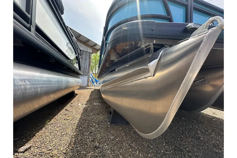 Slide: The Image of 2026 Godfrey Sweetwater 2286 SFLC pontoon boats, side view, showcasing sleek aluminum hulls. - 37