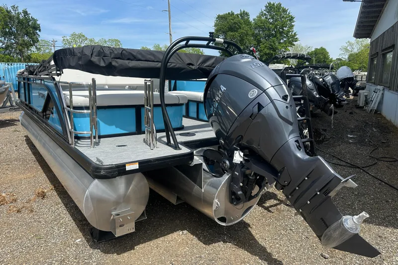 Slide: The Image of 2026 Godfrey Sweetwater 2286 SFLC pontoon boat with Yamaha outboard motor, parked outdoors. - 4