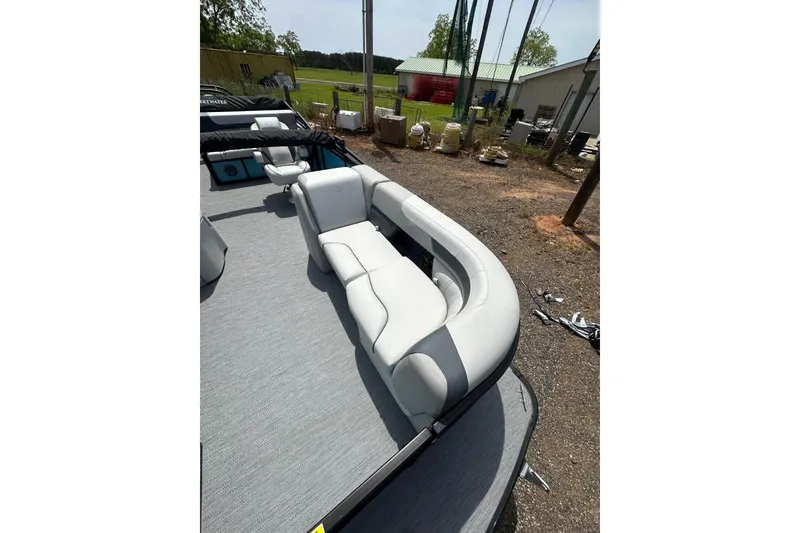 Slide: The Image of 2026 Godfrey Sweetwater 2286 SFLC boat interior with white seating and gray flooring. - 9