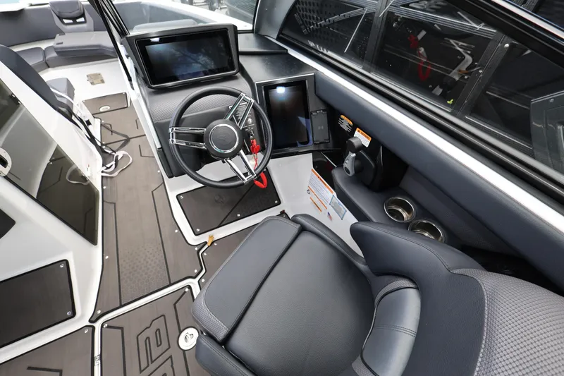 Slide: The Image of 2024 Scarab 285 ID boat interior with modern steering and digital displays. - 12