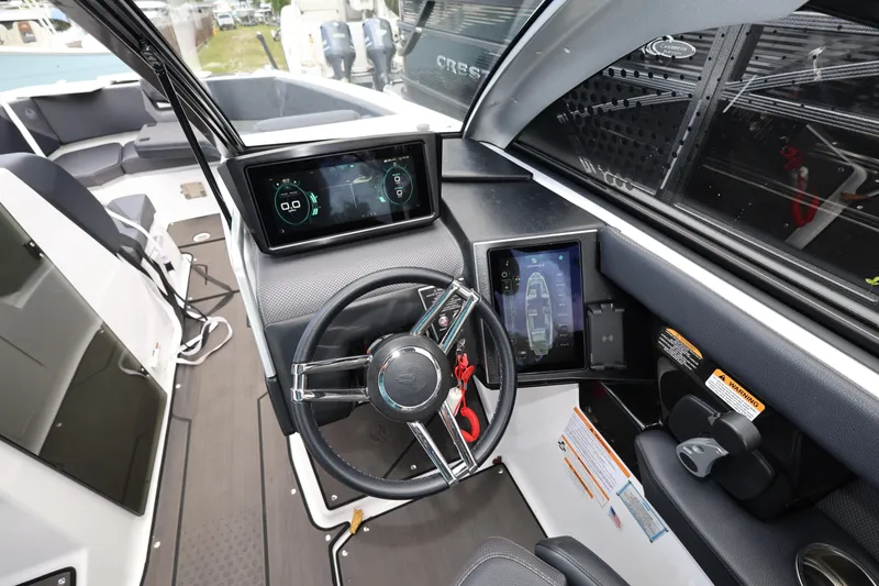 Slide: The Image of 2024 Scarab 285 ID boat cockpit with modern steering and digital displays. - 13