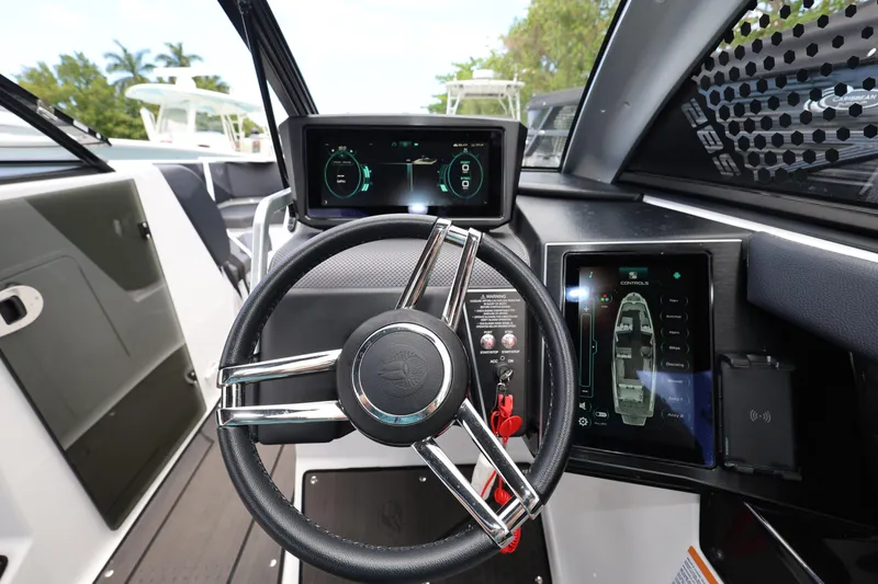 Slide: The Image of 2024 Scarab 285 ID boat dashboard with modern steering wheel and digital displays. - 14