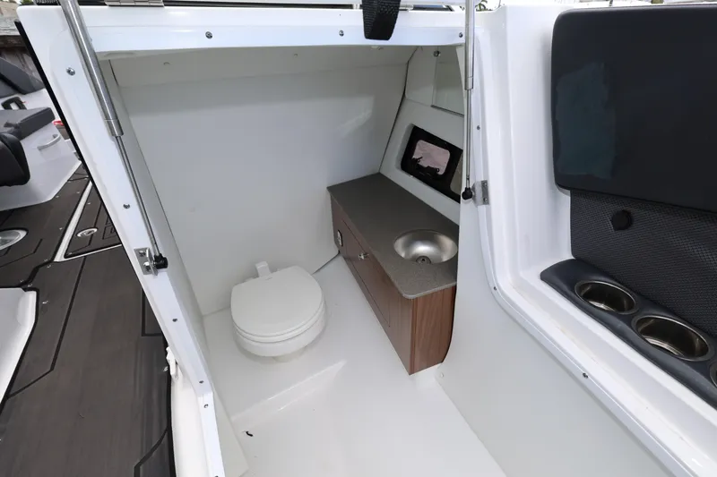 Slide: The Image of 2024 Scarab 285 ID boat interior with compact bathroom and sink. - 19