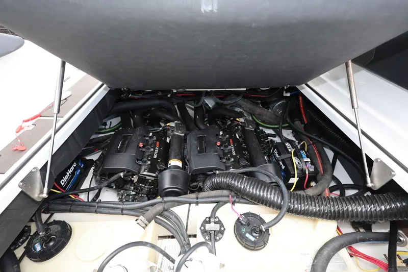 Slide: The Image of 2024 Scarab 285 ID boat engine compartment with Rotax engines and DieHard battery. - 22