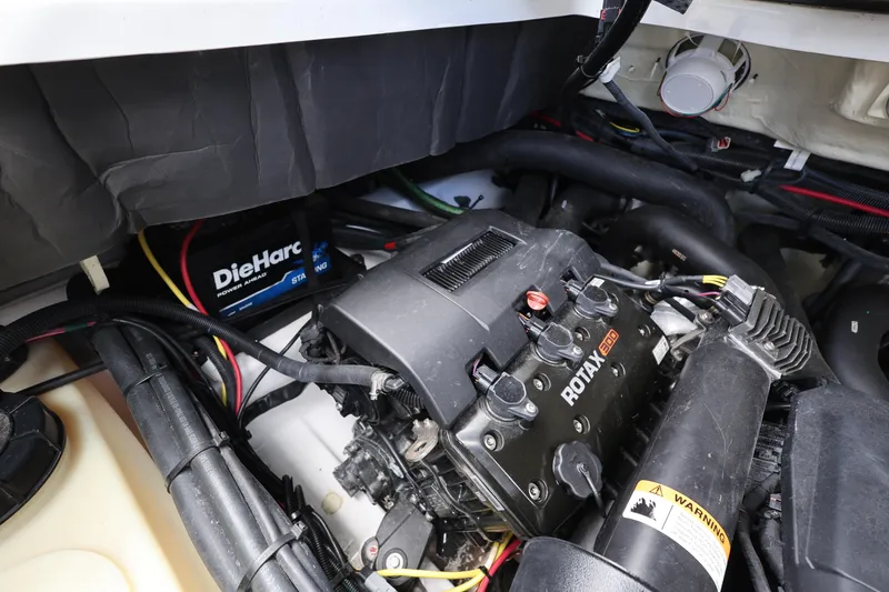 Slide: The Image of Engine compartment of 2024 Scarab 285 ID boat featuring Rotax engine and DieHard battery. - 25