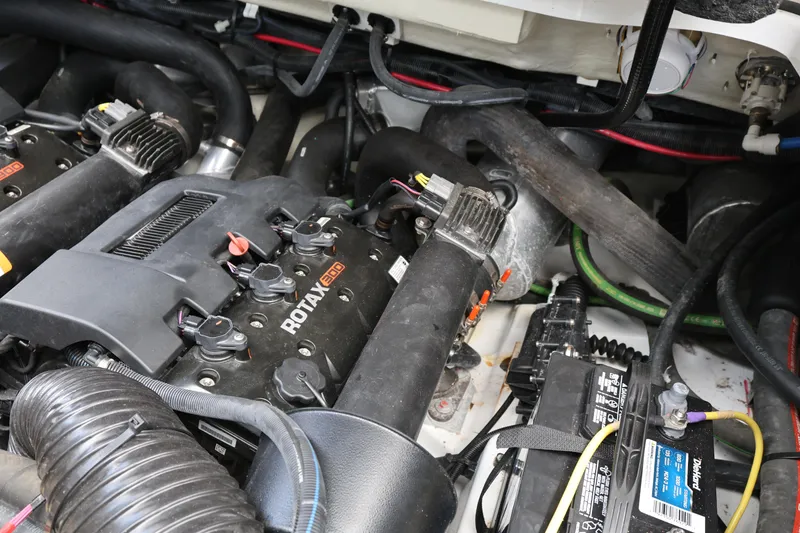 Slide: The Image of Engine compartment of 2024 Scarab 285 ID with Rotax 300 engines and battery. - 26