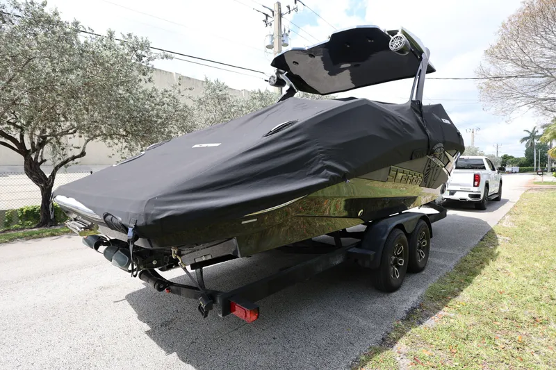 Slide: The Image of 2024 Scarab 285 ID boat on trailer, covered, parked on street. - 4