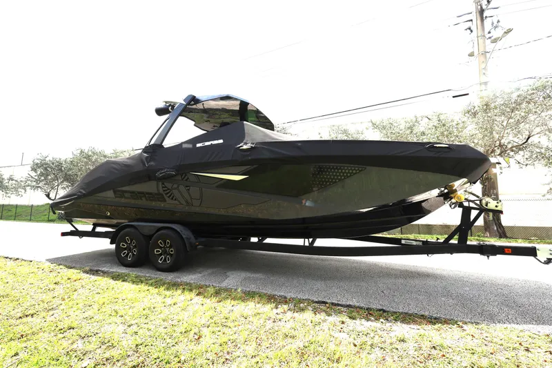 Slide: The Image of 2024 Scarab 285 ID boat on trailer, covered, parked on roadside. - 5