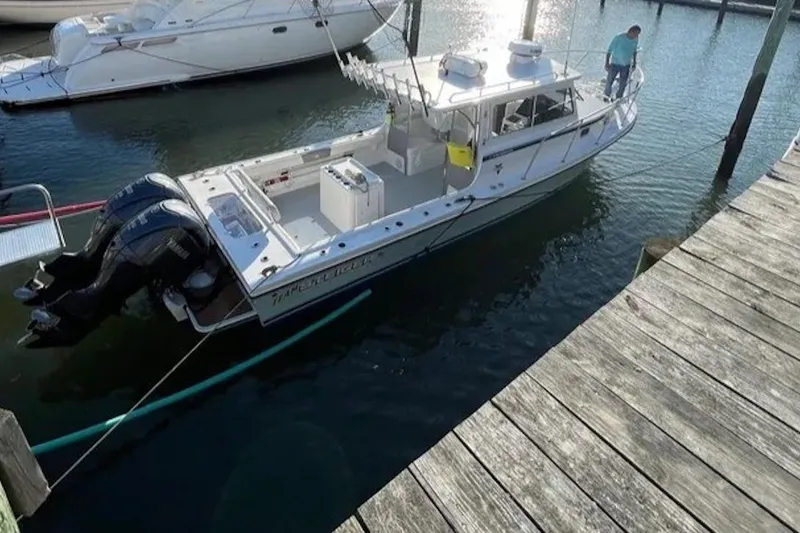 Slide: The Image of 2023 Steiger Craft 31 Fisherman boat docked at marina with outboard motors. - 3