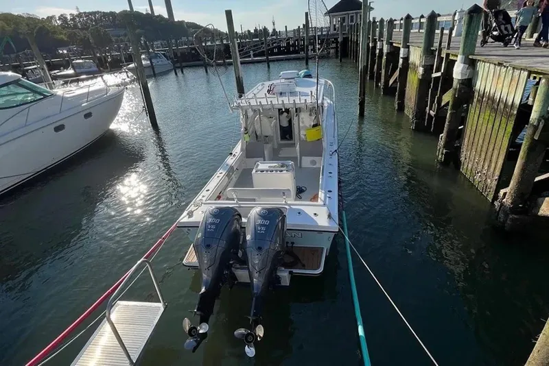 Slide: The Image of 2023 Steiger Craft 31 Fisherman docked at marina with twin outboard engines. - 4