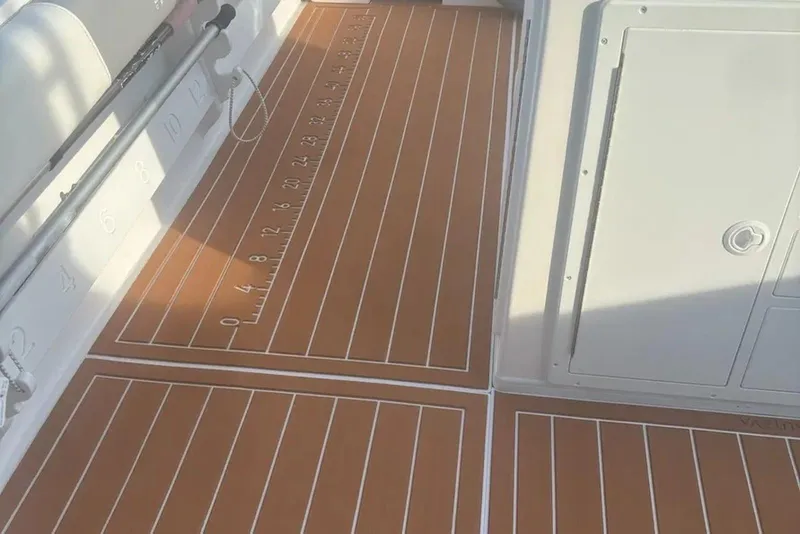 Slide: The Image of 2023 Steiger Craft 31 Fisherman boat deck with measurement markings and storage compartments. - 6