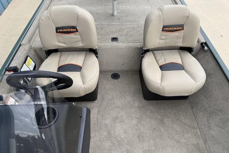 Slide: The Image of 2026 Tracker Bass Tracker Classic Limited boat interior with dual beige seats and steering console. - 10