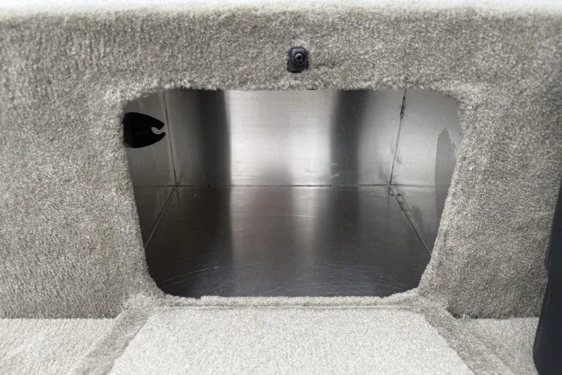 Slide: The Image of Storage compartment of 2026 Tracker Bass Tracker Classic Limited boat, carpeted interior. - 11