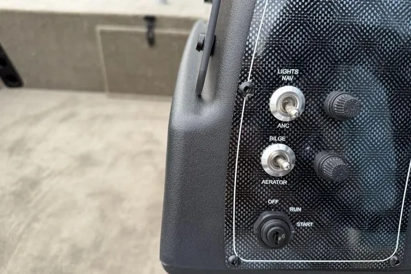 Slide: The Image of Control panel of 2026 Tracker Bass Tracker Classic Limited boat with switches and knobs. - 15