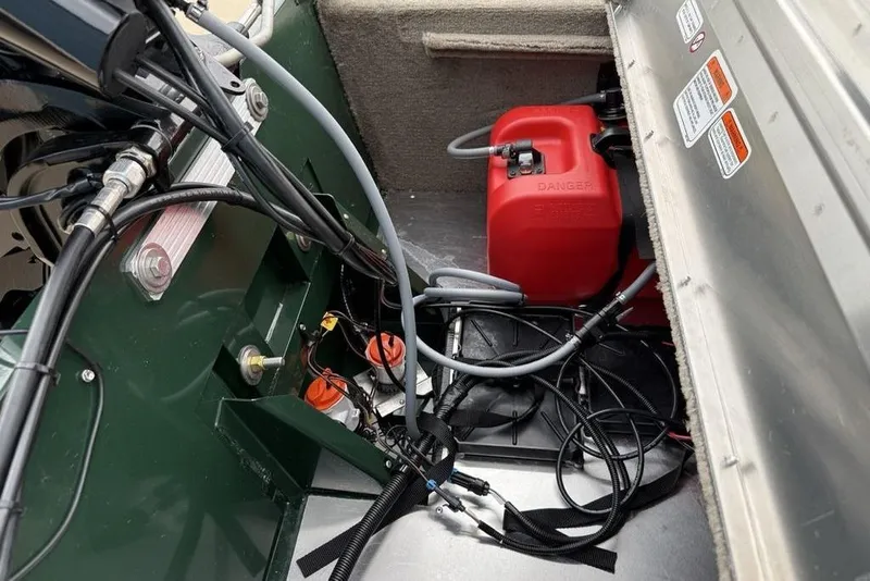 Slide: The Image of Interior view of a 2026 Tracker Bass Tracker Classic Limited boat, showcasing wiring and fuel tank. - 21