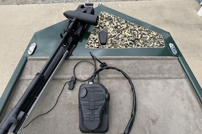 Slide: The Image of 2026 Tracker Bass Tracker Classic Limited boat deck with trolling motor and camouflage panel. - 4