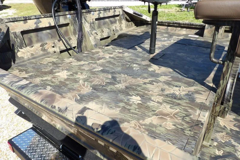 Slide: The Image of 2026 Crestliner 1860 Retriever CC Tunnel boat with camouflage deck design. - 10