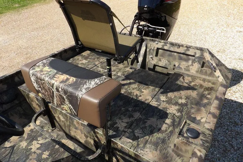 Slide: The Image of 2026 Crestliner 1860 Retriever CC Tunnel boat with camouflage seating and flooring design. - 11